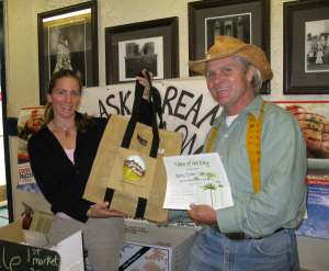 Julie Jordan of Alaska Dream Salmon receives the Table of the Day award from Kerry MacLane for the first Sitka Farmers Market of the season