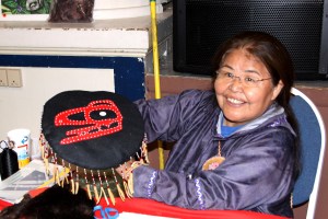 Sarah Williams shows off a hat she made to sell at the Sitka Farmers Market.