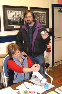 Sonja Koukel of the UAF Cooperative Extension Service's Juneau office checks pressure gauges for Perry Edwards of Sitka