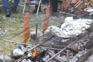 King salmon fillets and baked potatoes cook over an open fire at an open house and salmon bake hosted by Medvejie Hatchery on July 10, 2010.
