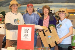 PHOTO COURTESY OF SITKA LOCAL FOODS NETWORK  Sitka Local Foods Network Board Member Doug Osborne, left, and Sitka Farmers Market Co-Director Mandy Griffith, right, present the Table of the Day Award to Dave Nicholls, second from left, and Charlotte A. Vanchura Candelaria of Sitka Sea Salt during the first Sitka Farmers Market of the summer on Saturday, July 16, 2011, at the Alaska Native Brotherhood Hall in Sitka, Alaska. Sitka Sea Salt is a new business that will manufacture sea salt for chefs and restaurant use. Dave and Charlotte received a tote bag full of bread, veggies and other prizes from the market. The next Sitka Farmers Market is from 10 a.m. to 2 p.m. on Saturday, July 30, 2011, at ANB Hall. To learn more about the Sitka Farmers Market, go to http://www.sitkalocalfoodsnetwork.org/. 