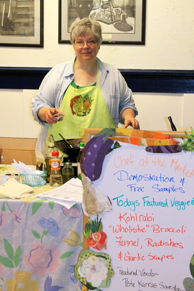 Suzan Brawnlyn, the Chef at the Market, holds a sample cup of honey miso-glazed black cod with broccoli and bok choy stir fry during a cooking demonstration on July 21, 2012, at the second Sitka Farmers Market of the season.