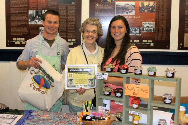 PHOTO COURTESY OF SITKA LOCAL FOODS NETWORK Sitka Farmers Market Co-Managers Garrett Bauer, left, and Sabrina Cimerol, right, present the Table Of The Day Award to Jean Frank of Jeans Jellies Etc. at the second market of the season on Saturday, July 20, at the Alaska Native Brotherhood Founders Hall in Sitka. Jean has been a regular vendor at the Sitka Farmers Market since it started, selling jellies, jams, honey and more. She received a gift bag with fresh produce, fresh rhubarb jam and a copy of the Alaska Farmers Market Cookbook. This is the sixth year of Sitka Farmers Markets, hosted by the Sitka Local Foods Network. The next market is from 10 a.m. to 1 p.m. on Saturday, Aug. 3, at the Alaska Native Brotherhood Founders Hall, 235 Katlian St. For more information about the Sitka Farmers Markets and Sitka Local Foods Network, go to http://www.sitkalocalfoodsnetwork.org/.