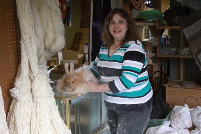 Bobbi Daniels of The Sawmill Farm grooms a rabbit at The Sawmill Farm Feed and Fiber store on Katlian Street. Bobbi raises some rabbits for their hair (to make yarn) and others for meat.