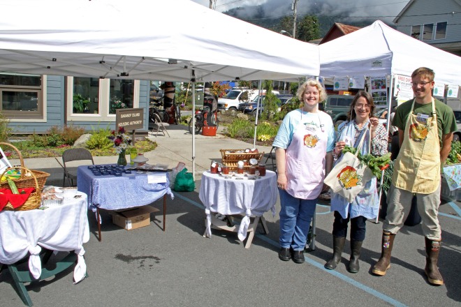 Sitka Farmers Market Manager Debe Brincefield, left, and Sitka Farmers Market Assistant Manager Francis Wegman-Lawless, right, present the Table Of The Day Award to Linda Wilson of Sea View Garden at the third Sitka Farmers Market of the 2015 summer on Saturday, Aug. 1, at the Alaska Native Brotherhood Founders Hall in Sitka. Wilson is a longtime vendor at the market, selling rhubarb and other veggies from her garden, rhubarb jams and jellies, banana bread, rhubarb black tea, and her homemade jewelry. Wilson received a gift bag with fresh greens and fresh rhubarb. This is the eighth year of Sitka Farmers Markets, hosted by the Sitka Local Foods Network. The next market is from 10 a.m. to 1 p.m. on Saturday, Aug. 15, at the Alaska Native Brotherhood Founders Hall, 235 Katlian St. Don’t forget Aug. 2-8 is National Farmers Market Week, so even though we don't have a full market scheduled the Sitka Local Foods Network will host a produce booth at the Sitka Seafood Festival Marketplace from noon to 6 p.m. on Saturday, Aug. 8, at Sheldon Jackson Campus. For more information about the Sitka Farmers Markets and Sitka Local Foods Network, go to http://www.sitkalocalfoodsnetwork.org/ or check out our Facebook page at https://www.facebook.com/SitkaLocalFoodsNetwork. (PHOTO COURTESY OF SITKA LOCAL FOODS NETWORK)