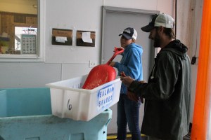 AriannaShovelsIceIntoToteWithJasonCroft