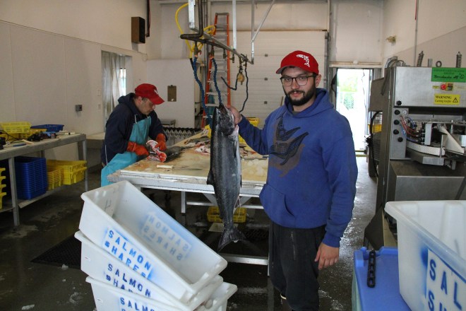 MarshSkeeleHoldsSalmonAsGuyFilletsBehind